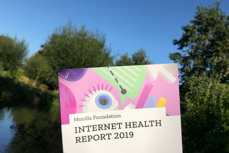 Book internet heath report against backdrop of blue sky, river and trees