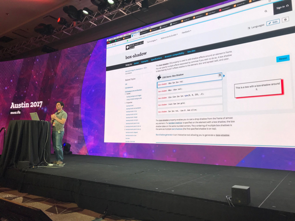 Speaker with slide that shows MDN docs about box shadow with a CSS editor