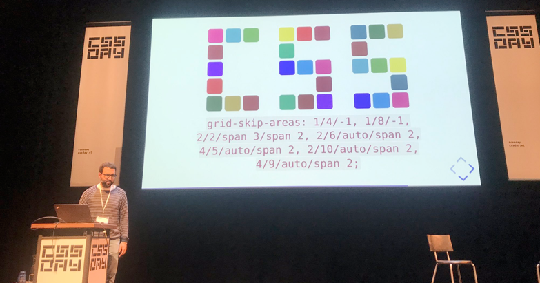 Slide that has squares forming the word css with code grid skip areas and syntax with numbers and slashes